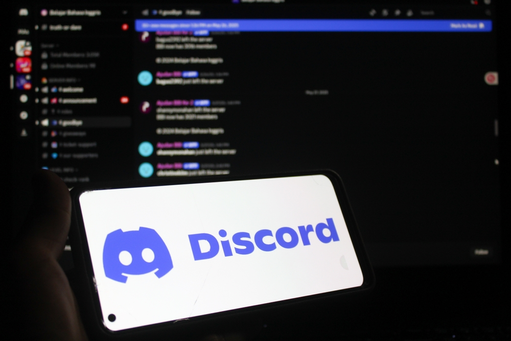 Discord chat open on computer with Discord logo floating in front on a white computer screen - feature image for discord lawsuit page by File Abuse Lawsuit