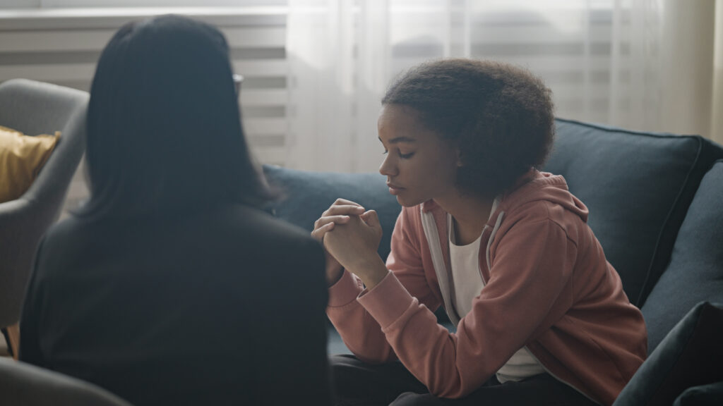 Teen girl survivor of sexual abuse at a California juvenile detention center talks to therapist representing medical costs compensation